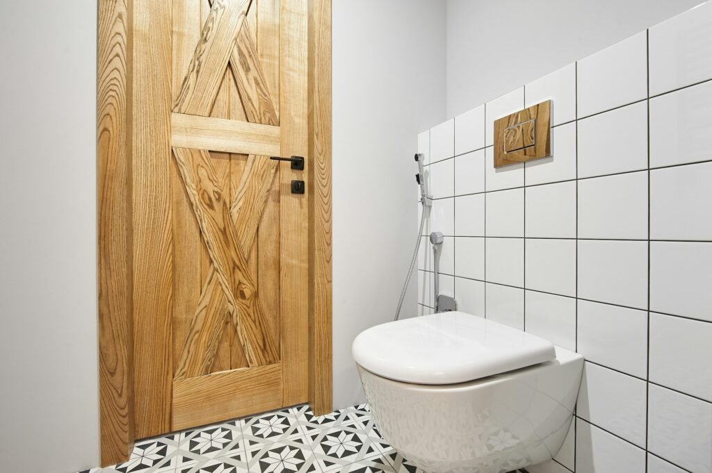 Modern flush toilet or WC in small bathroom with push button flush